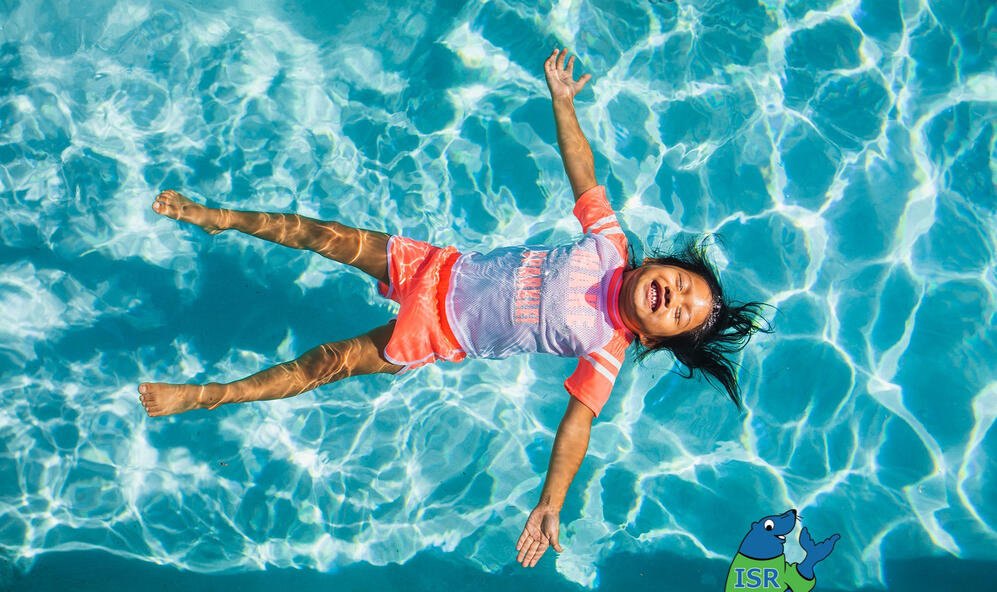 Child floating in a pool